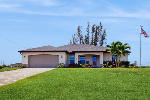 a house with an american flag in a yard at Cocktail Cove in Cape Coral