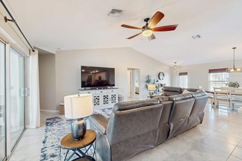 a living room with a couch and a ceiling fan at Cocktail Cove in Cape Coral