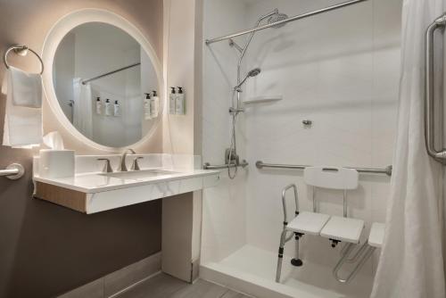 a bathroom with a sink and a shower with a mirror at FOUND Hotels, Santa Barbara, Series by Marriott in Santa Barbara