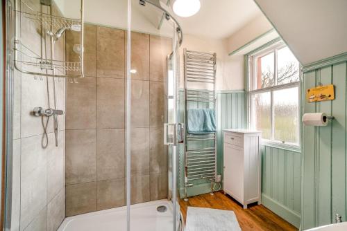 a bathroom with a shower with a glass door at 5 Bed in Shiskine oc-b33664 in Shiskine