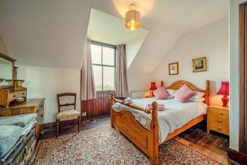 a bedroom with a bed and a chair at 5 Bed in Shiskine oc-b33664 in Shiskine