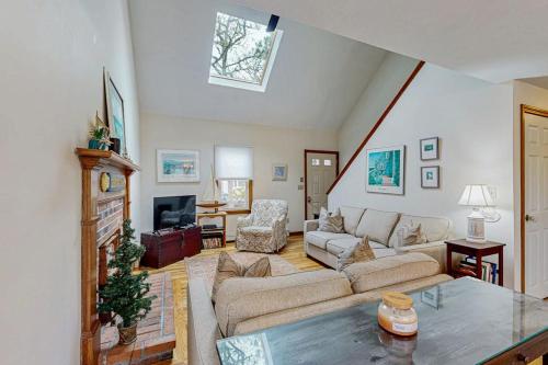 a living room with a couch and a fireplace at Skylight Tonight in South Dennis