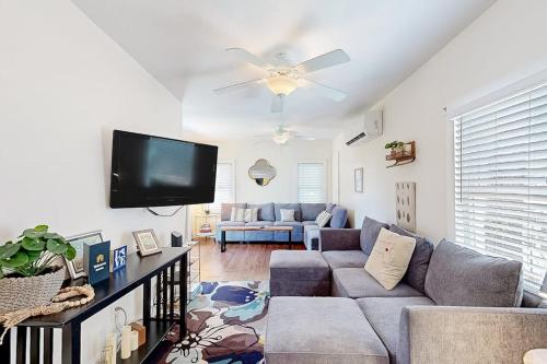 a living room with a couch and a flat screen tv at Oak Bluffs Cottage in Oak Bluffs