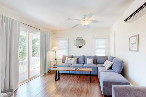 a living room with a blue couch and a ceiling fan at Oak Bluffs Cottage in Oak Bluffs