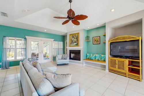 a living room with a couch and a flat screen tv at Tranquil Haven in Marco Island