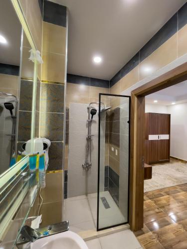 a bathroom with a shower and a sink at Pyramids Sunshine View in Giza