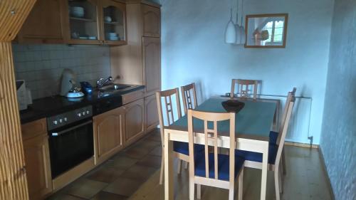 uma cozinha com uma mesa e duas cadeiras em Schweizerblick em Hänner