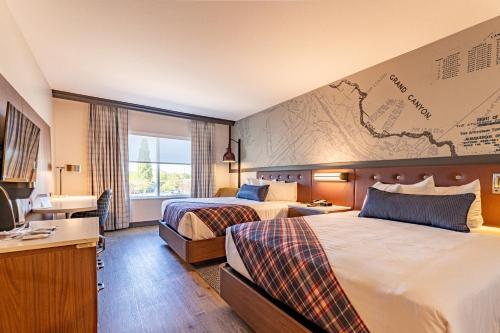 a hotel room with two beds and a map on the wall at Grand Canyon Railway Hotel in Williams
