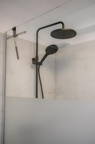 a shower in a room with a glass wall at Apartment am Berg II in Grünstadt