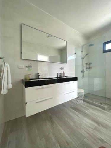 a bathroom with a sink and a mirror at Penthouse In Tracadero Oceanfront Infinity Pool in La Laguna