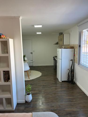a kitchen with a white refrigerator in a room at Monoambiente Lavalle Lujan in Luján