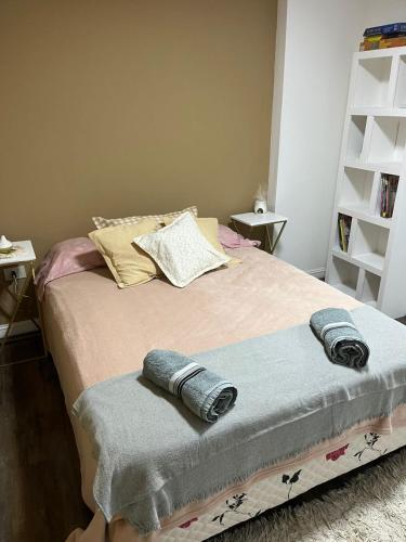 a bedroom with a bed with two towels on it at Monoambiente Lavalle Lujan in Luján
