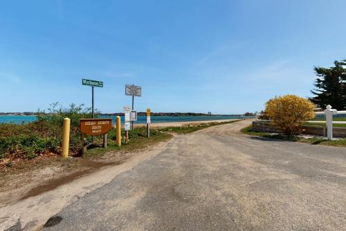 an empty road with street signs on the side of the road at Buttermilk Bliss in Wareham