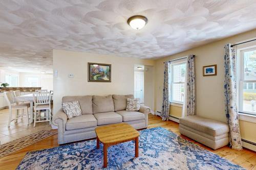 a living room with a couch and a table at Buttermilk Bliss in Wareham