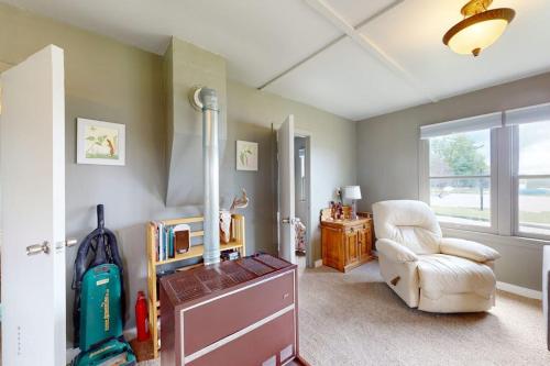 a living room with a chair and a table and a window at Green Cottage Getaway in Frankfort