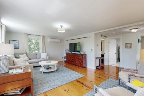 a living room with a couch and a table at Blissful Island Haven in Oak Bluffs