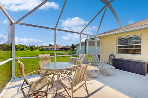 a patio with a table and chairs on a patio at Sunny Way in Rotunda-West