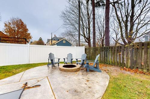 a backyard with two benches and a fire pit at South Haven Retreat in South Haven