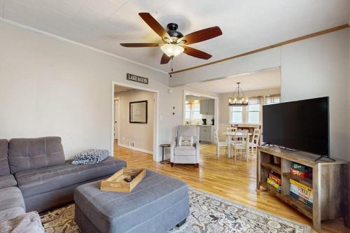 a living room with a couch and a flat screen tv at South Haven Retreat in South Haven