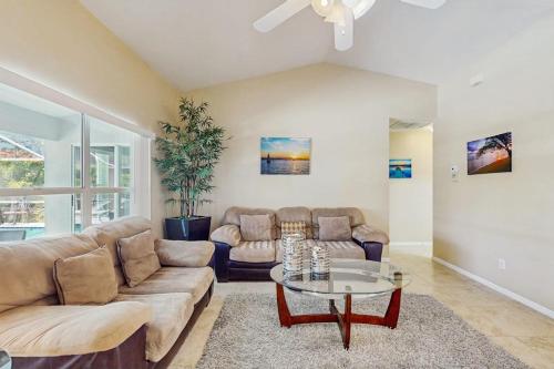 a living room with a couch and a table at Marco Sands in Marco Island