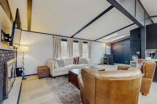 a living room with a couch and a fireplace at La Casa Chikaming in Union Pier