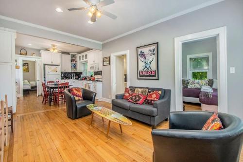 a living room with two couches and a dining room at Hydrangea House in New Buffalo