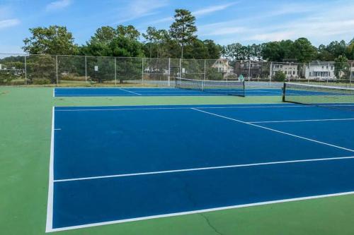 a tennis court with two tennis nets on it at Tranquil Woods in Ocean Pines