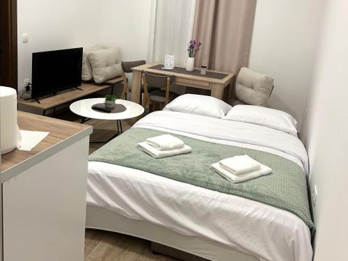 a bedroom with a bed with towels on it at Nanchev Apartments in Gevgelija