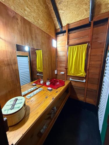 a bathroom with a wooden counter and a sink at El Amado in General Alvear