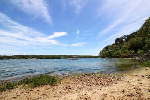 a beach with boats in a body of water at The CAVU Mansion on Bellevue in Oklahoma Heights