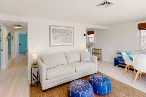 a living room with a white couch and a table at Calm Waters in Bourne