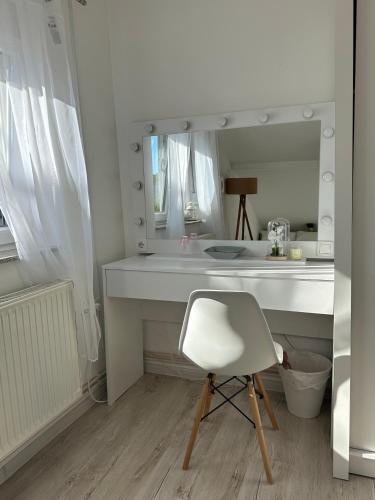 a white desk with a chair and a mirror at Prestige in Arandelovac