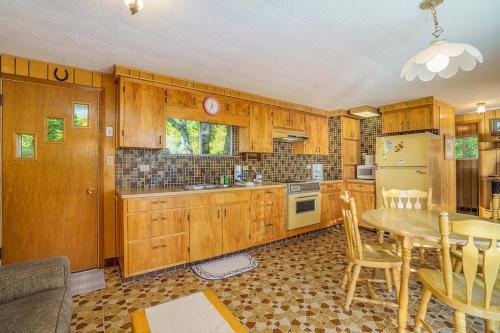 a kitchen with wooden cabinets and a table and a dining room at Grandma's Sandbox in Beulah