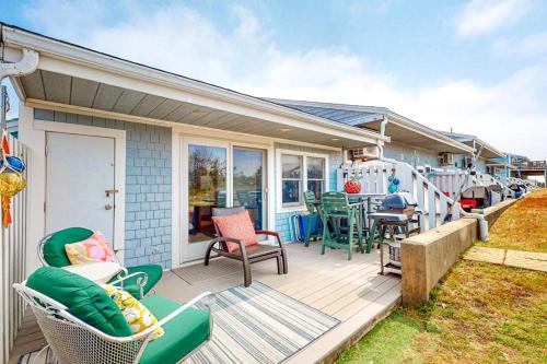 a house with a deck with chairs and a table at Riviera Sunset in Chatham