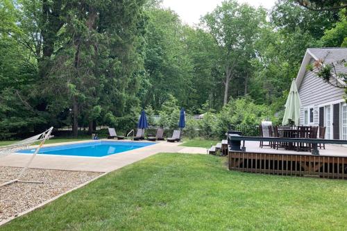 a backyard with a swimming pool and a house at Ravenswood Pool House in Sawyer