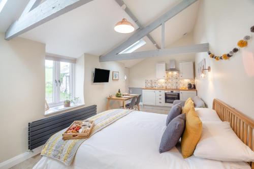 a bedroom with a large bed with a tray on it at 1 Bed in Abergele oc-bow134 in Llanfair Talhaiarn
