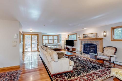 a living room with a couch and a fireplace at Tranquil Getaway in Wellfleet