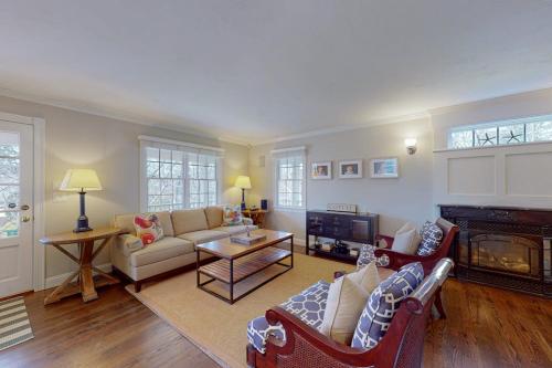 a living room with a couch and a fireplace at Cotuit Mannor in Cotuit