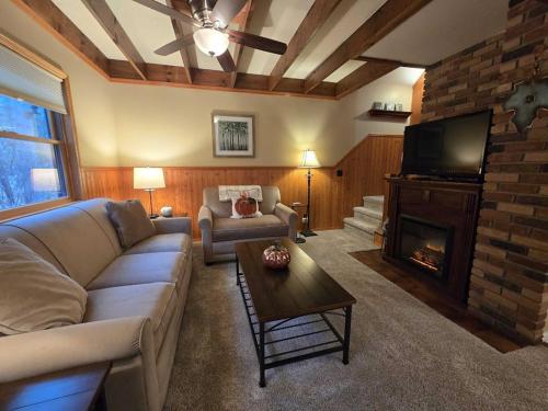 a living room with a couch and a fireplace at Saltbox in Thompsonville