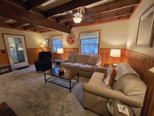 a living room with a couch and a table at Saltbox in Thompsonville