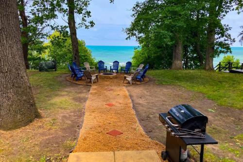a group of chairs sitting on the ground near the ocean at Casual Lake Living in Union Pier