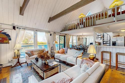 a living room with two couches and a table at Soundmeadow House in Oak Bluffs
