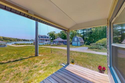 a porch of a house with a view of a yard at Cataumet Cottage in Bourne