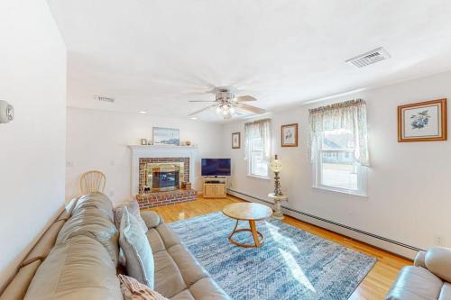 a living room with a couch and a fireplace at Cape Estate 6 in South Dennis