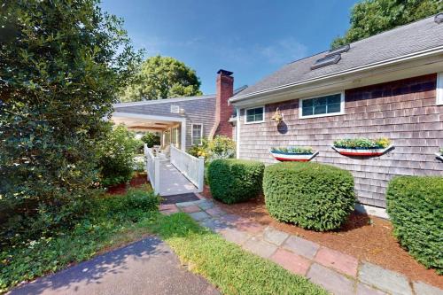 a house with twootted plants on the side of it at Seaside Park Retreat in West Hyannisport
