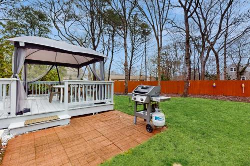 a barbecue grill with a gazebo in a yard at Hyannis Beach House in Hyannis