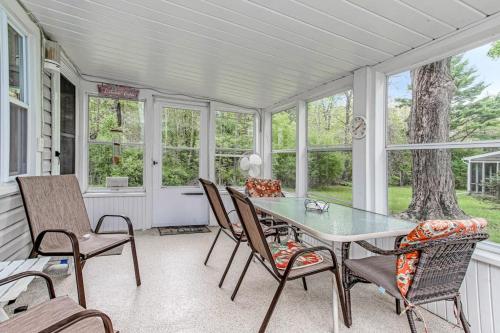 a dining room with a glass table and chairs at Lakeside Living in Lakeside