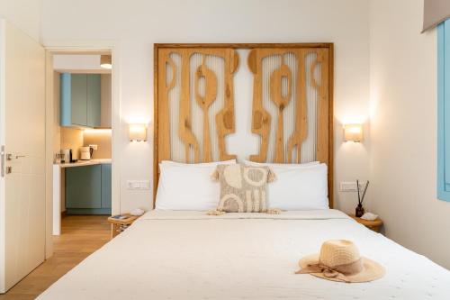a bedroom with a bed with a hat on it at Olea Blue in Skiathos