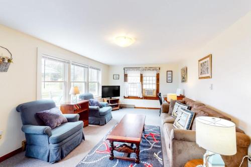 a living room with a couch and chairs and a table at Nauset Beach Buddy in Orleans