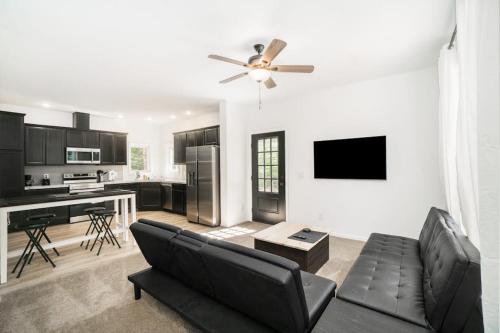 a living room with a couch and a kitchen at Stay Awhile in Honor